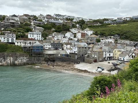 Coastal village with colorful houses and a small beach.