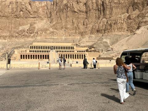Temple of Hatshepsut with people walking in the foreground.
