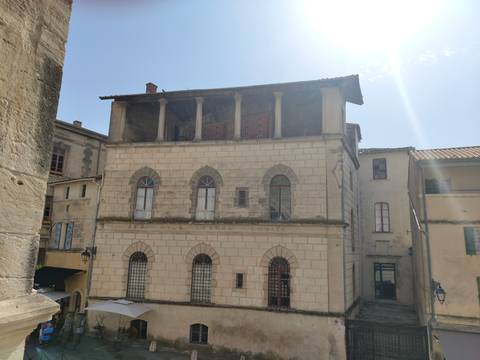 Old building with Romanesque architecture and arches.