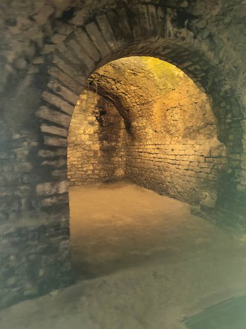Stonewalled chamber with an arched doorway.