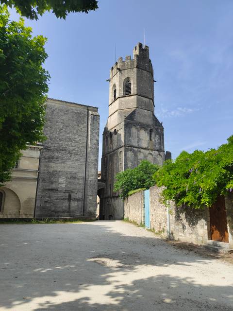 View of a church with a tower beside a wall.