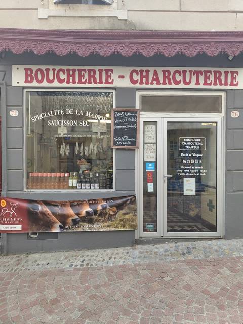       Shopfront of a French charcuterie with signage.
  