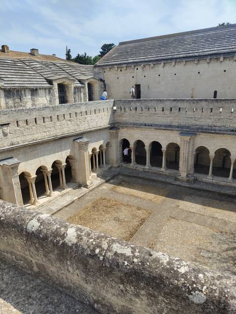 Sunny courtyard with classical columns and arches.
