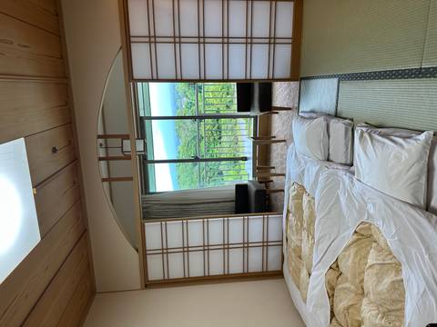 A traditional Japanese room with a view of nature from the window.