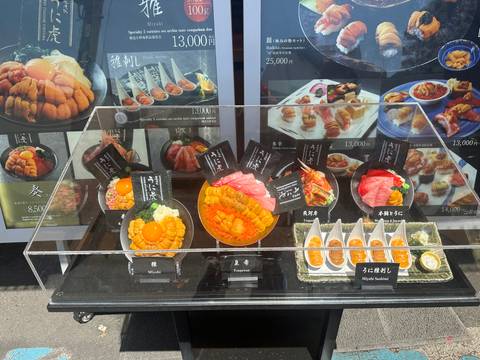       Display of various seafood dishes in a glass case outside a restaurant.
  