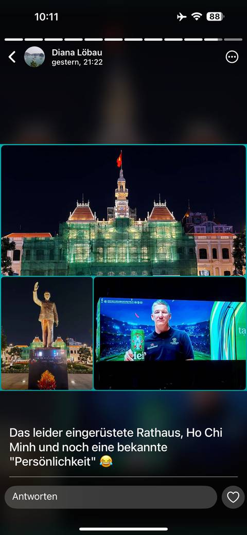       Night scene of historic building and statue under renovation.
  