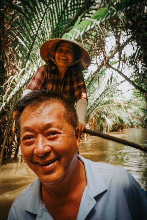       Portrait of a happy person in a boat on a river.
  