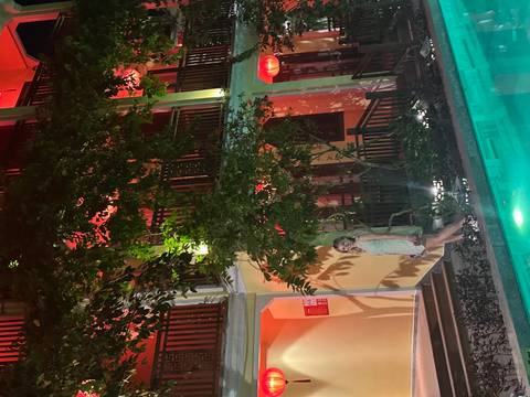       Person posing in front of a hotel pool.
  