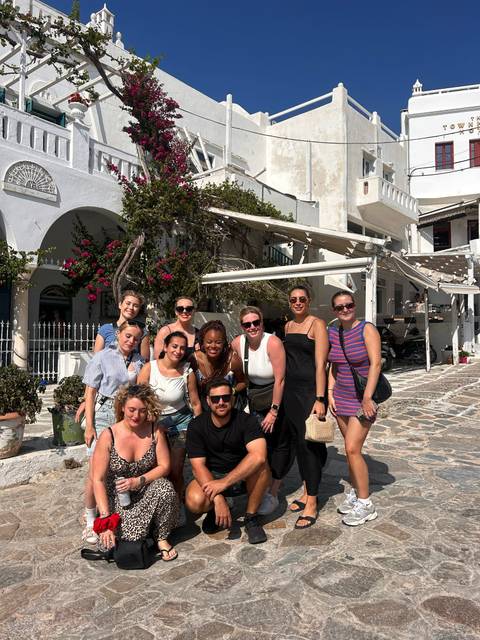 Group of people posing in a picturesque Greek street.