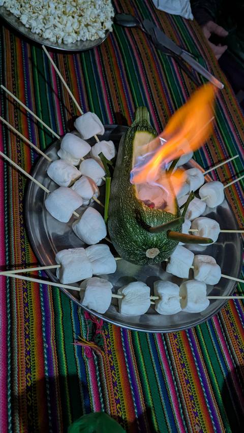 A plate of marshmallows around a burning avocado.