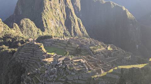 Aerial view of Machu Picchu with mountains in the background.