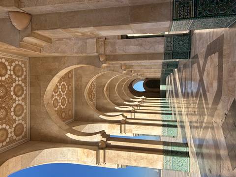       A series of ornate arches and columns with decorative tiles.
  