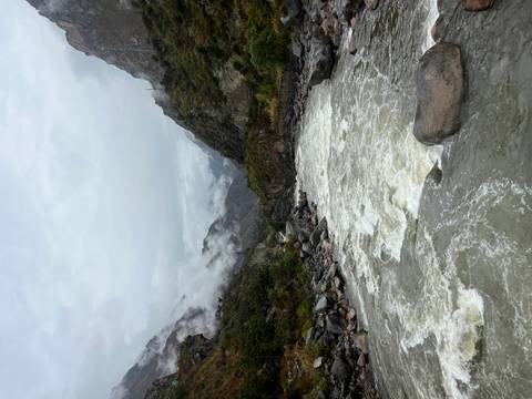 Rushing river through a mountainous landscape.