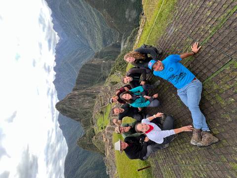 Group of people at Machu Picchu, smiling and posing.
