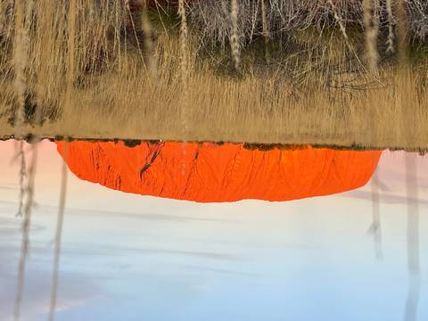       Uluru rock formation glowing red at sunset.
  