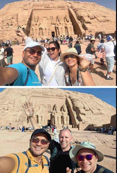 Tourists posing at an ancient temple site.