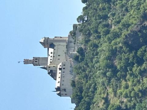 A castle on a hill with a clear blue sky.
