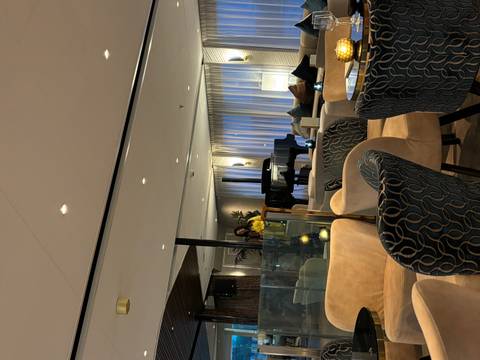 People inside a lounge with comfortable seating and a piano.