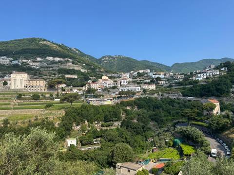       Scenic view of a town with mountains in the background.
  