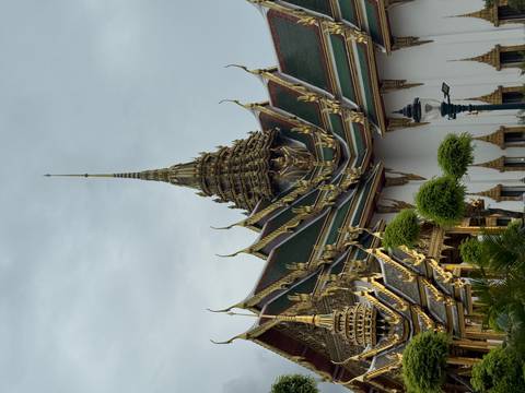       Intricately designed golden temple with pointed spires.
  