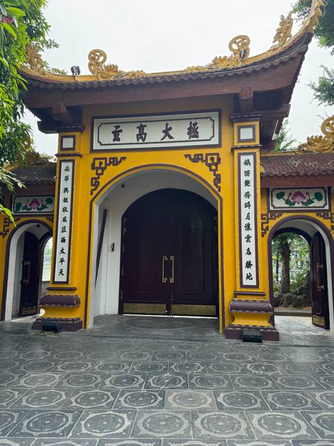       Traditional gate with Chinese inscriptions and aesthetic design.
  