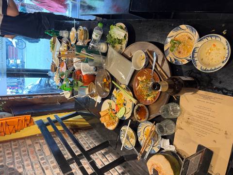       Messy dining table with various empty and half-eaten dishes.
  