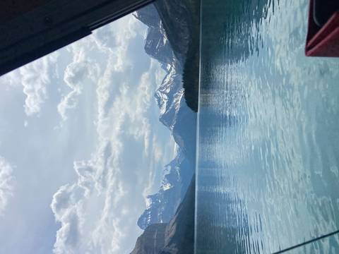      Pristine lake with mountains in the background, partially cloudy sky.
  