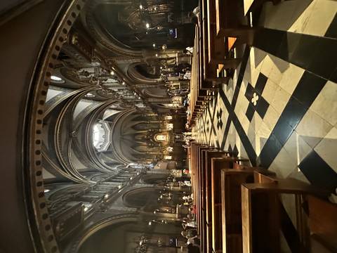 Interior of a church with ornate decorations and pews.