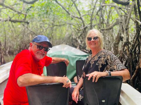 Couple enjoying a boat ride through mangroves.