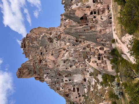 Rocky mountain with carved caves and structures.