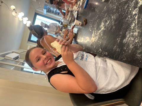 Smiling person in a cooking class.