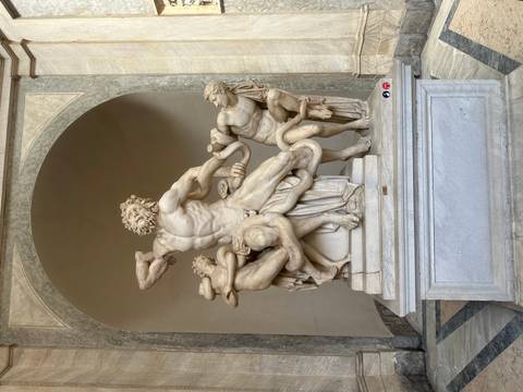       Ancient marble statue in a museum setting.
  