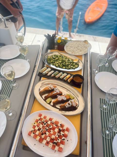 Elegant meal setup with various dishes and wine glasses.