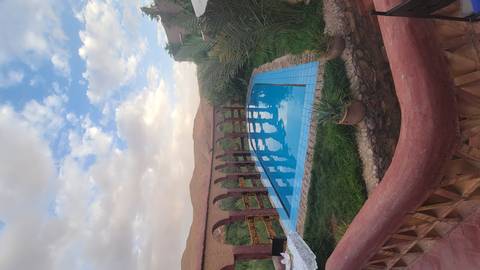 Swimming pool overlooking a desert landscape.