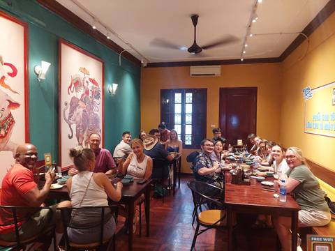 Group of people dining inside a decorated restaurant.