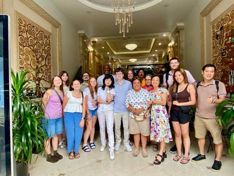 Group of travelers gathered in a hotel lobby.