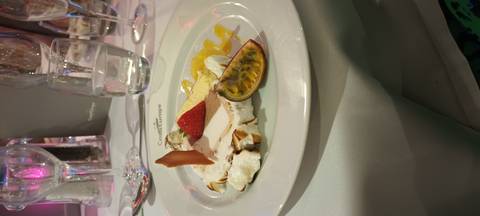       Dessert plate with a variety of fruit and sauce garnishes.
  