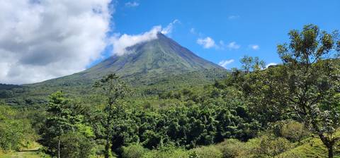 Majestic volcano with lush greenery in the foreground.
