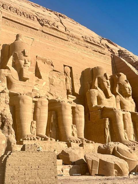 Colossal statues of Abu Simbel in warm sunlight.