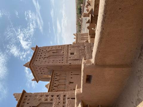A historic kasbah with desert landscape.