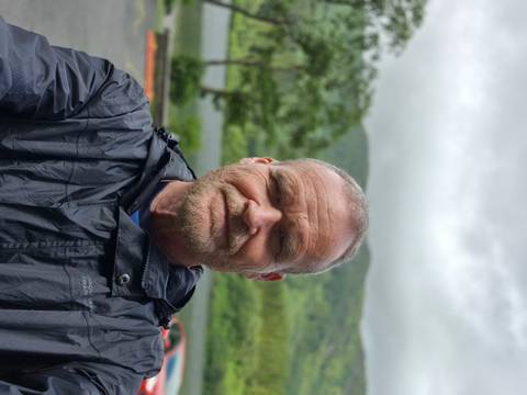 Portrait of a person with a scenic background.