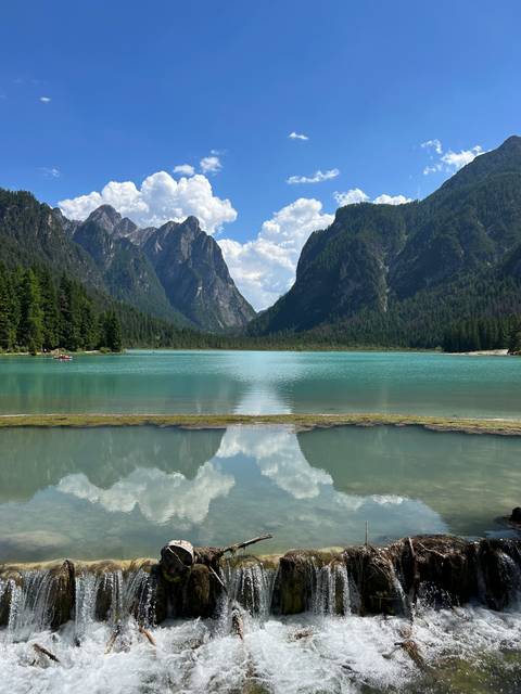       Turquoise lake surrounded by steep mountains.
  