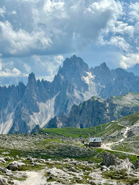       Dramatic mountain peaks under a partly cloudy sky.
  