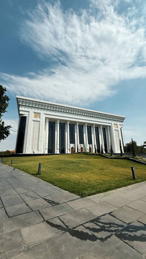 Large, ornate building with columns and arched windows.