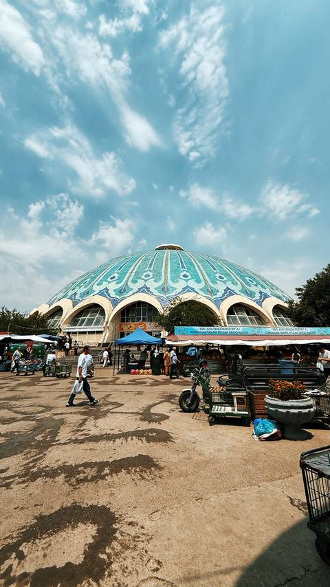       Market with a large dome roof and vendors.
  