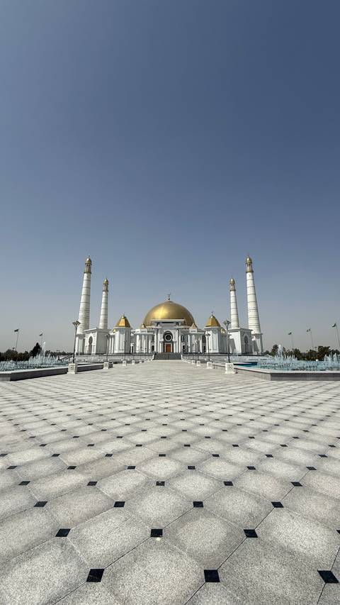       Golden-domed building with surrounding minarets.
  