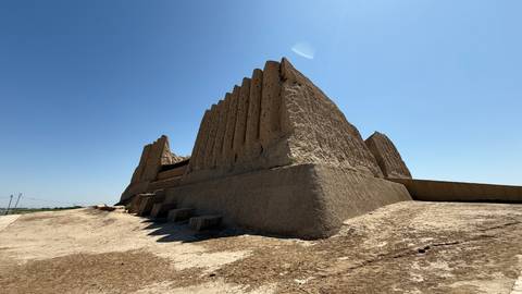       Ruins of an ancient structure against a blue sky.
  