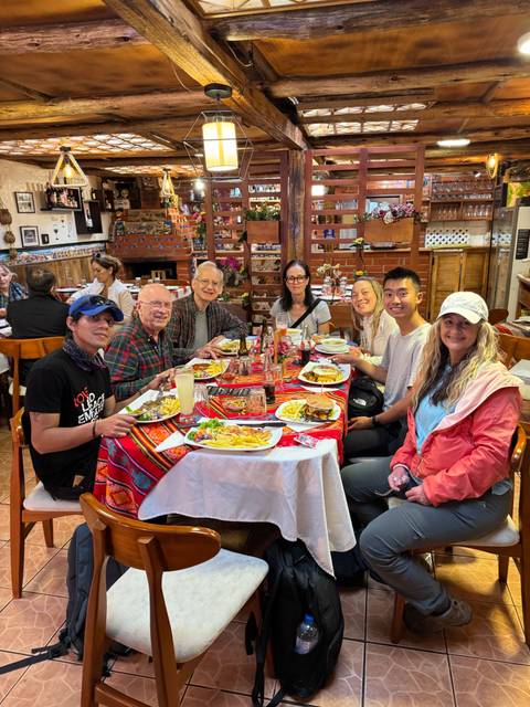       People enjoying a meal at a restaurant with colorful decor.
  