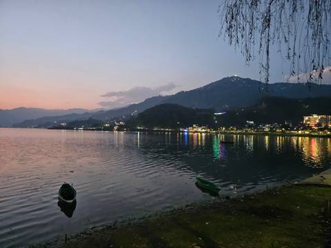 Serene lakeside view at dusk with reflections.