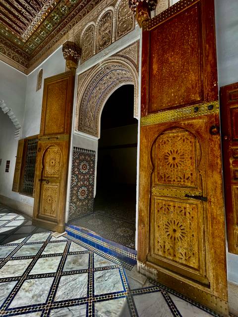Ornate doors with intricate geometric patterns and mosaic tiles.